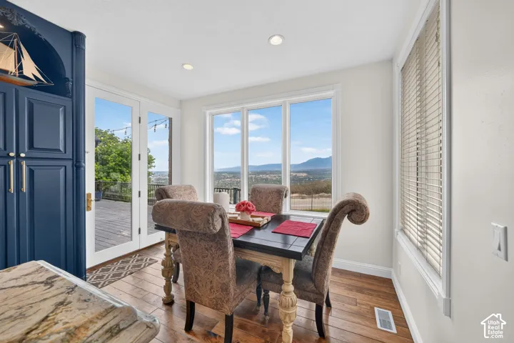 Dining area featuring wood-finish flooring and extensive natural light