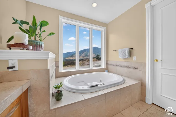 Built-in jetted tub with expansive window providing mountain scenery