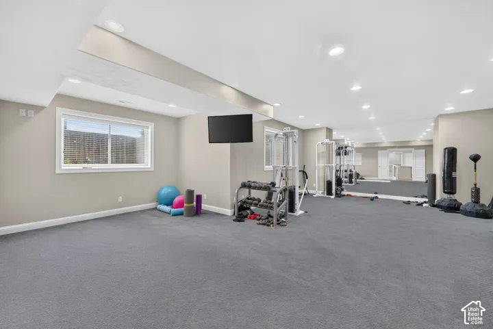 Expansive finished lower level featuring recessed lighting and gray carpet flooring