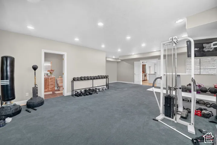 Spacious lower level room featuring recessed lighting and gray wall-to-wall carpeting