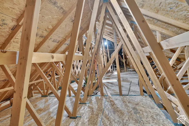 Exposed attic framing with engineered wood trusses and oriented strand board (OSB) sheathing
