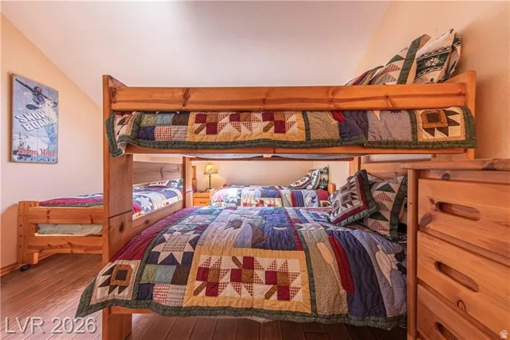 Custom-built bunk beds in a room with wood-finish flooring