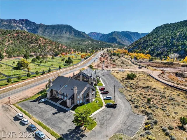 Multi-story residential buildings featuring dark shingle roofing and light-toned siding
