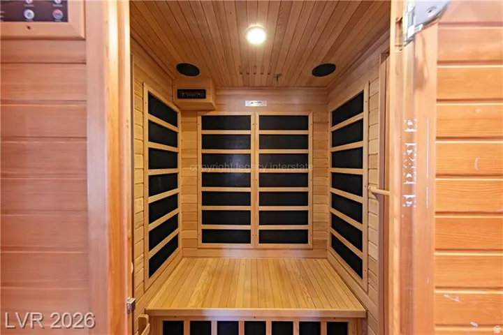 Built-in cedar sauna with slatted wood paneling, integrated heating elements, and overhead lighting