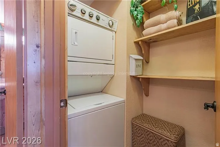 Integrated stacked washer and dryer unit with overhead wood shelving