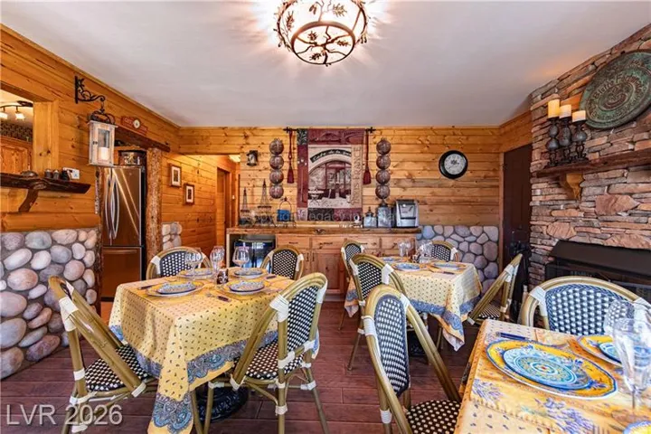 Dining area featuring wood-finish flooring and extensive wood paneling