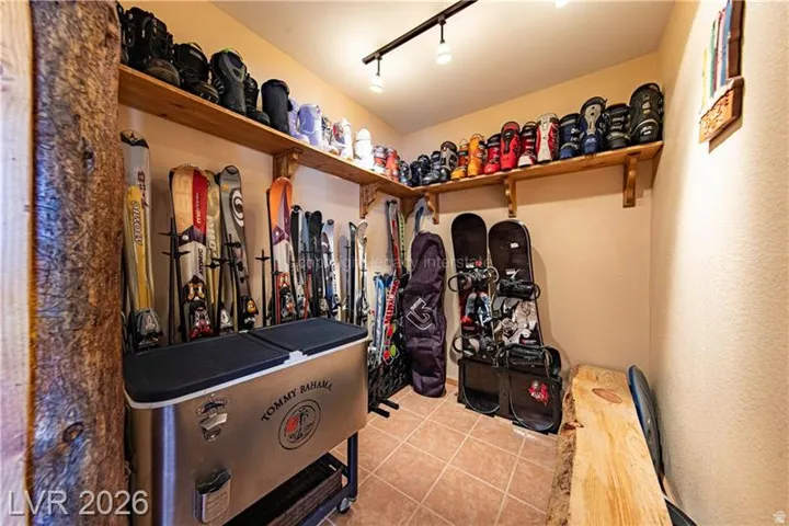 Dedicated storage room featuring light-toned walls and tile flooring