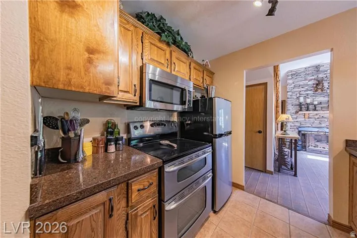 Kitchen featuring wood-finish cabinetry, stainless steel appliances, and durable countertop surfaces