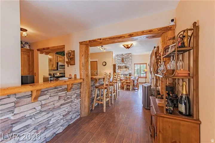 Stone veneer bar-height counter featuring a wood-finish top and structural wood beams