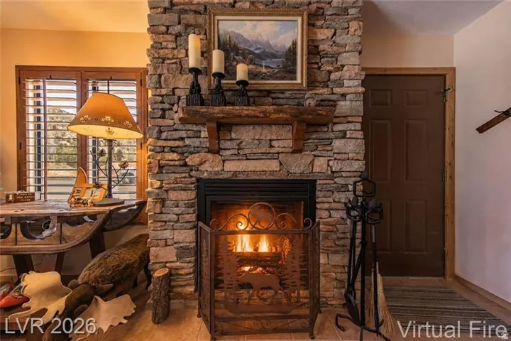 Stone-clad fireplace with a wood mantel