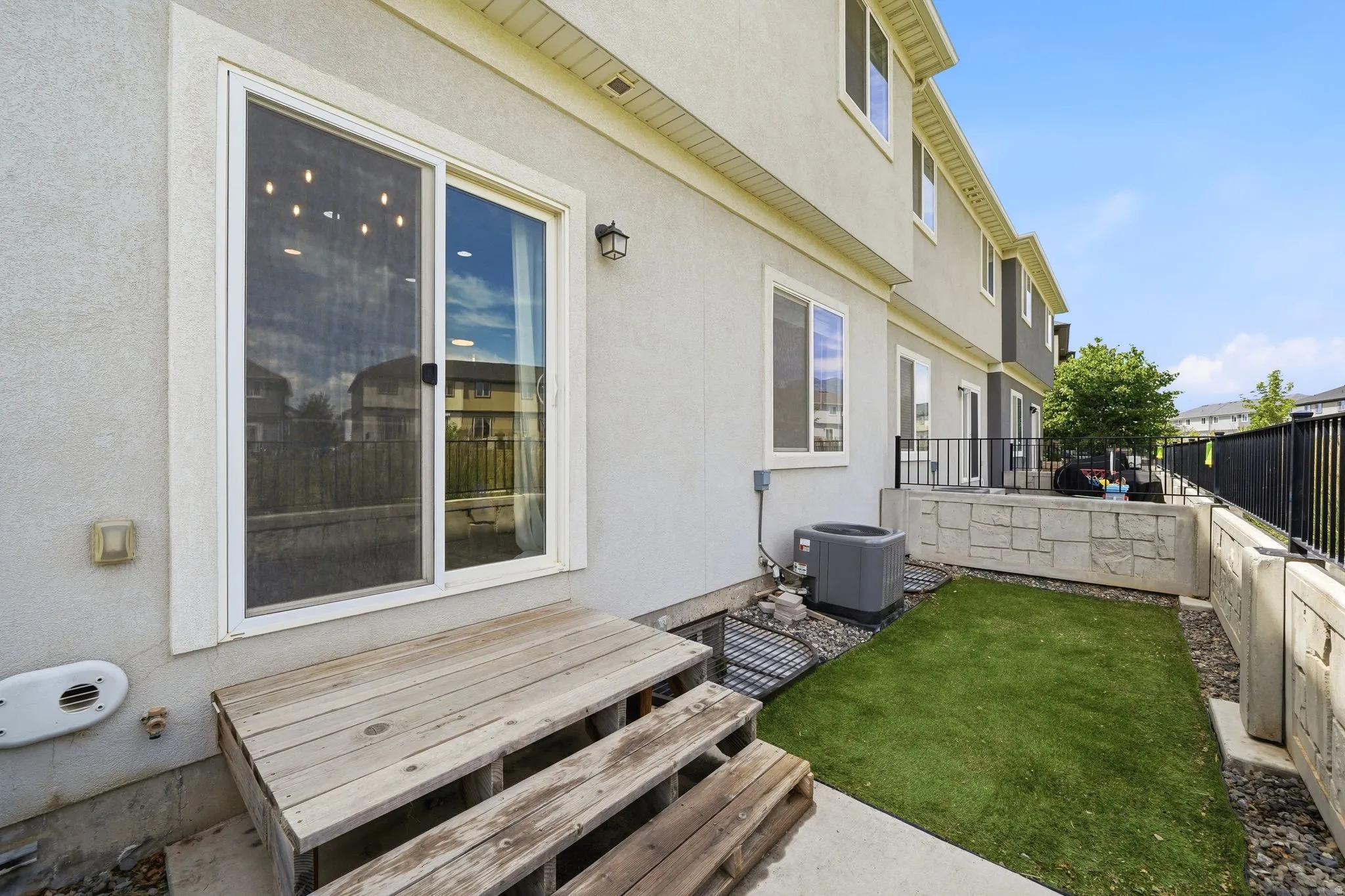 Sliding glass door opening to an exterior wood-finish deck