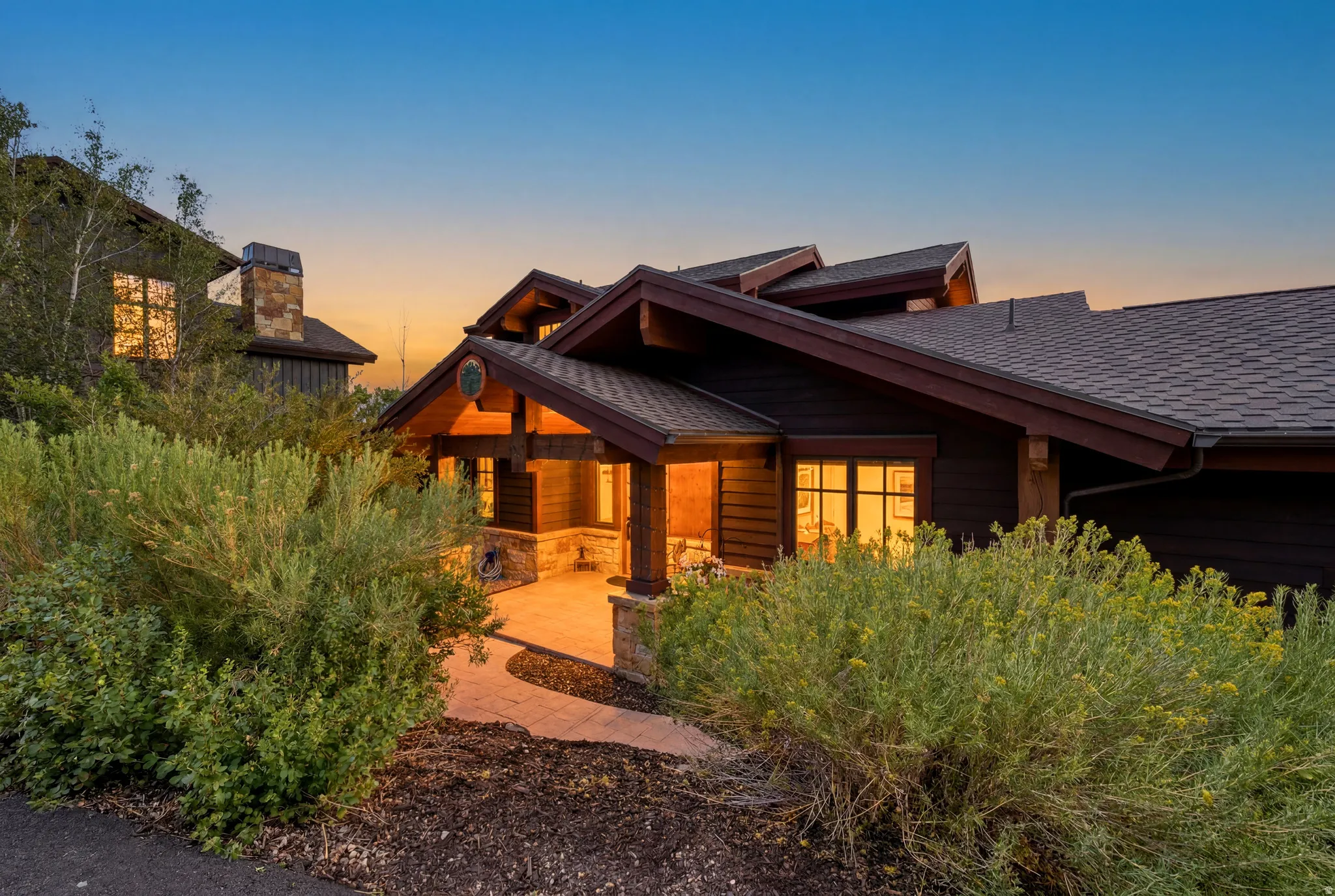 Craftsman-style home featuring rich wood siding and a multi-gabled roofline