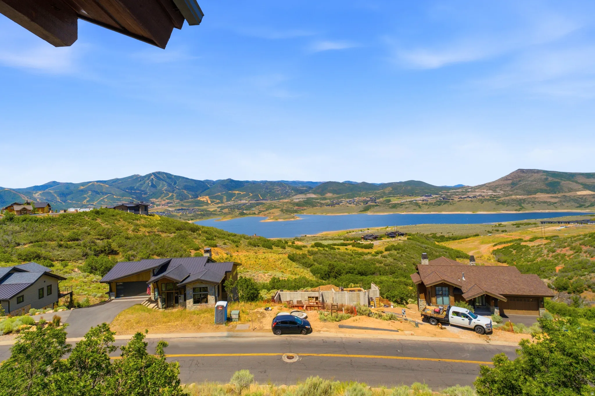 Expansive Deck Views natural landscape featuring a prominent lake, distant mountains, and green hillsides
