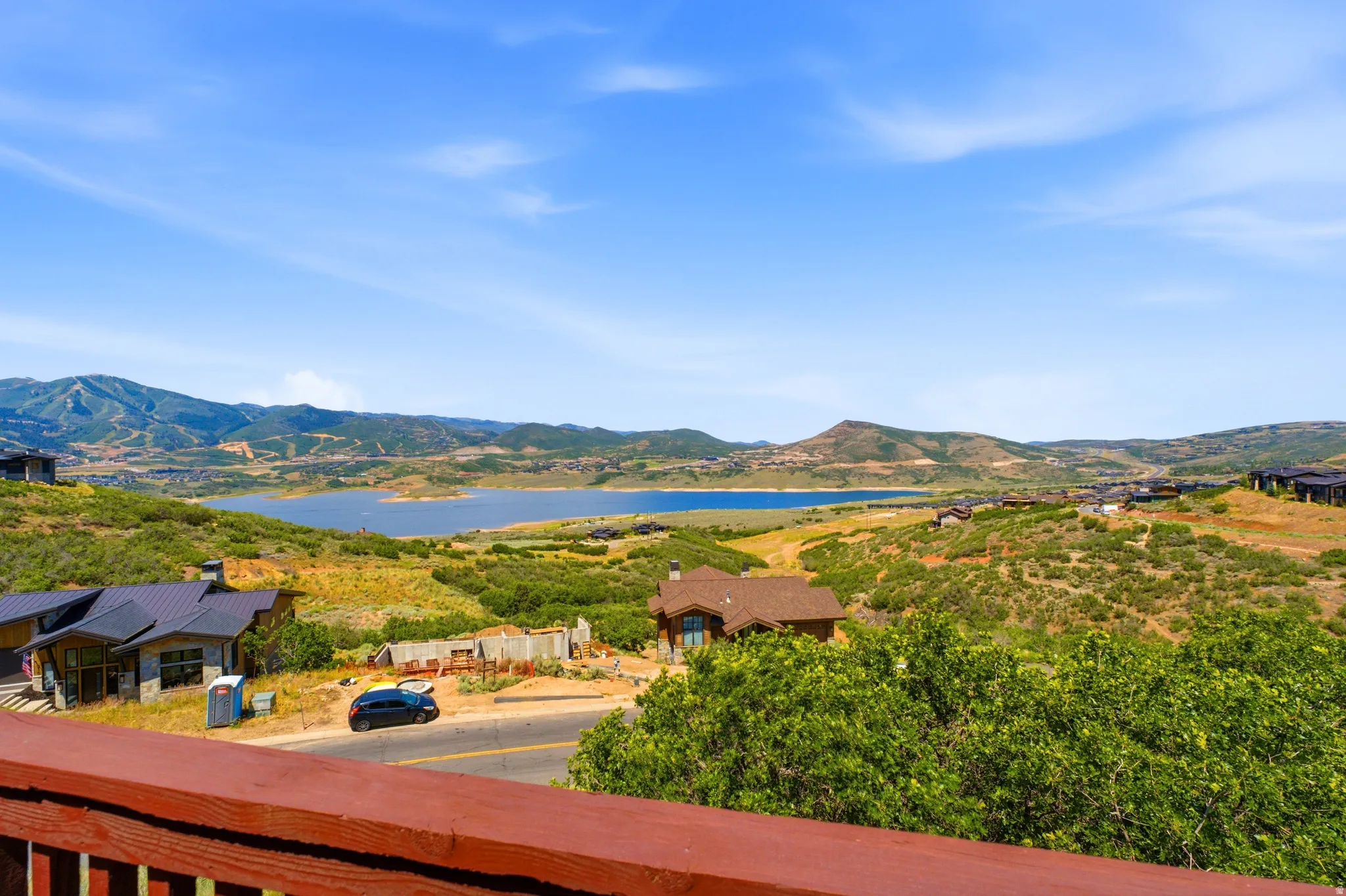 Deck Views - lake and mountain scenery from a private balcony with a rich wood railing
