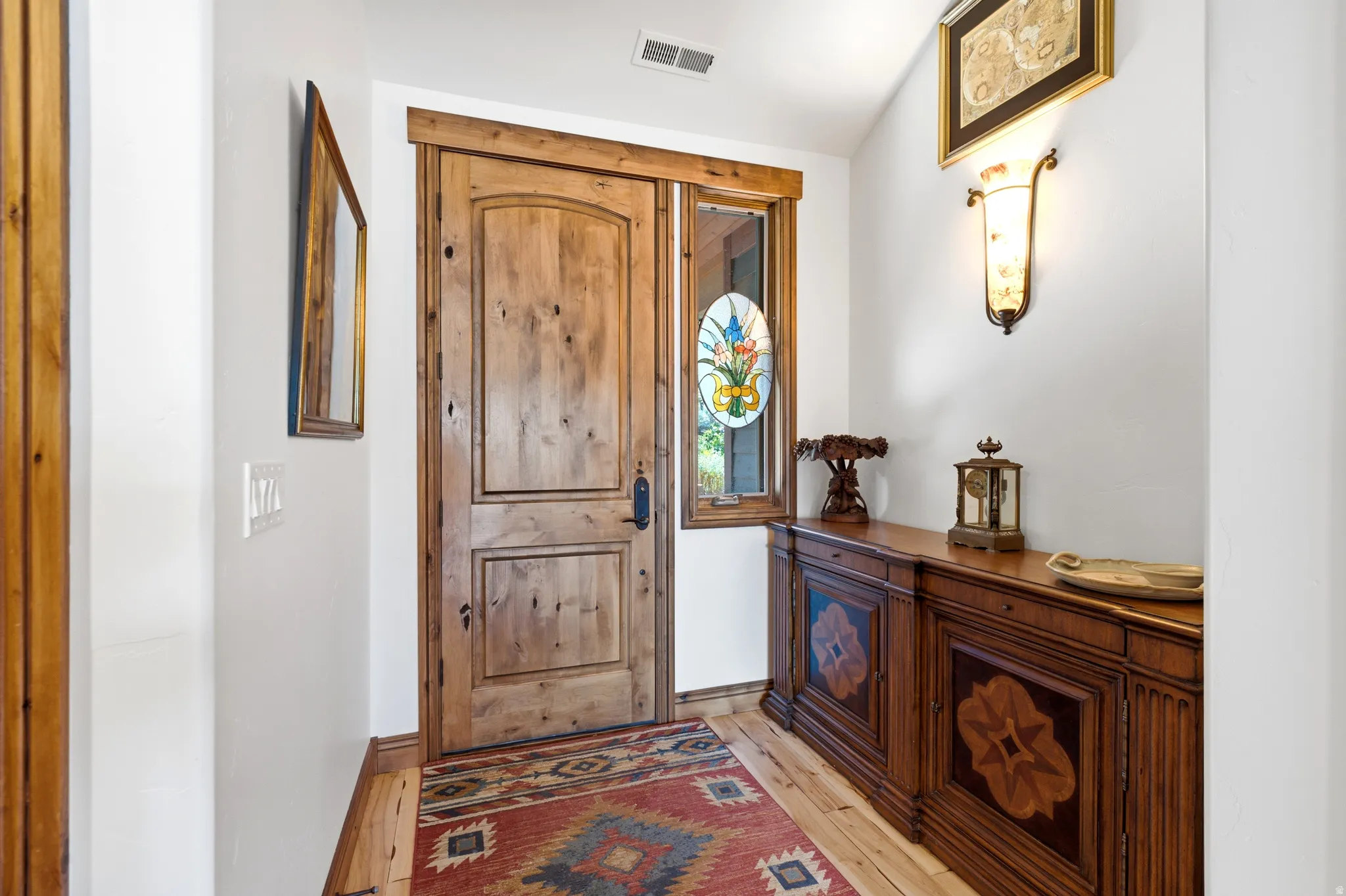 Substantial wood-plank entry door with dark hardware