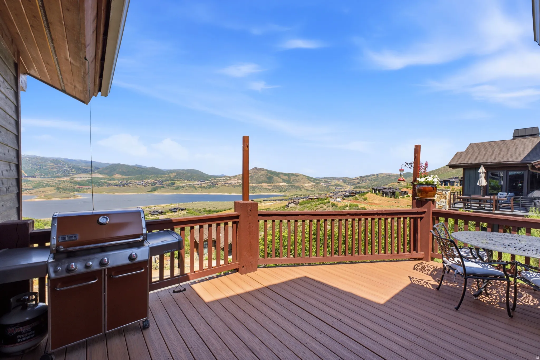 Expansive Deck Views outdoor deck featuring wood-finish composite decking and a wooden railing