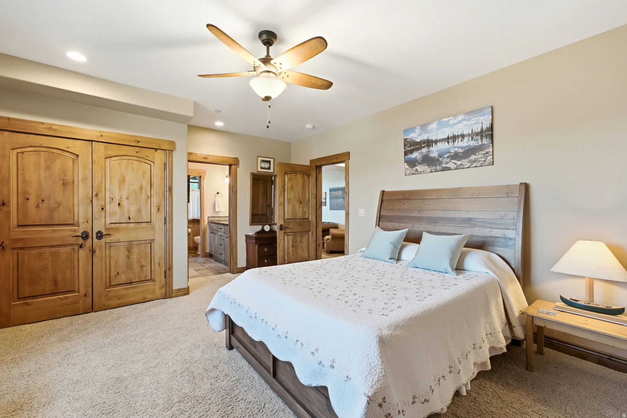 Carpeted room featuring natural wood doors, a ceiling fan with integrated lighting, and recessed lighting