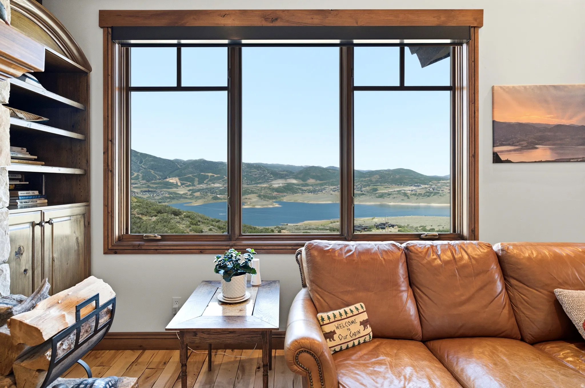 Triple window with a wood frame, offering extensive views of the reservoir and surrounding terrain