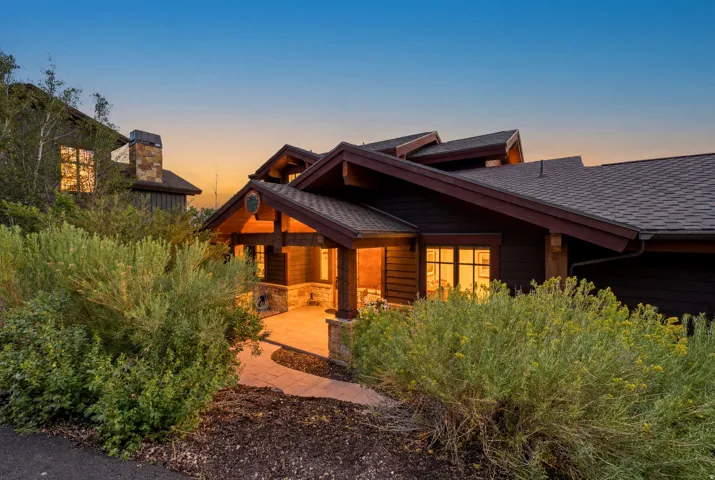 Craftsman-style home featuring rich wood siding and a multi-gabled roofline