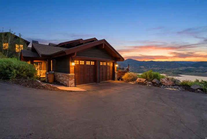 Craftsman-style exterior featuring a multi-car garage with wood-finish doors and transom windows