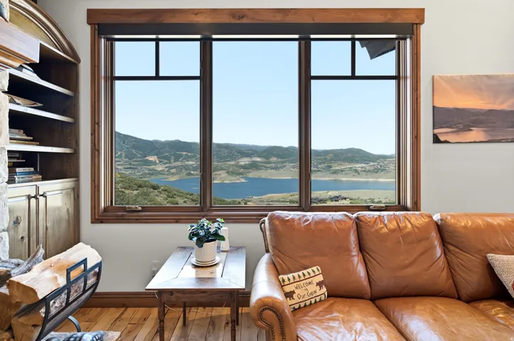 Triple window with a wood frame, offering extensive views of the reservoir and surrounding terrain