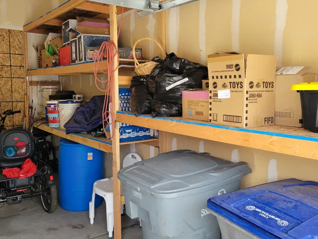 Built-in wooden shelving provides generous storage capacity within the garage