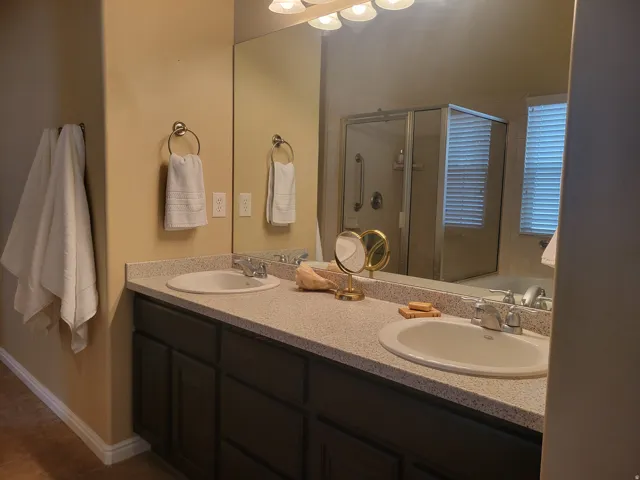 Dual vanity with integrated sinks and speckled countertops
