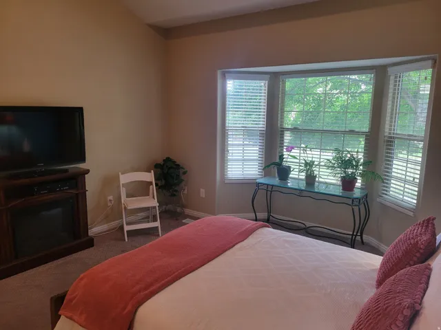 Bay window featuring multiple large windows and white louvered blinds