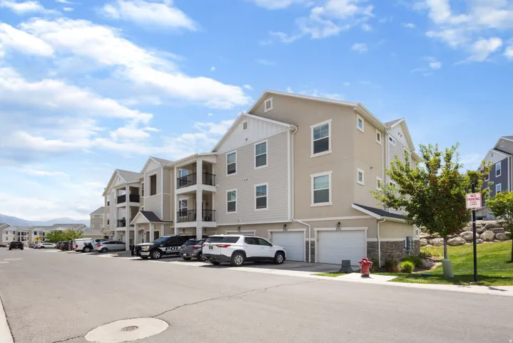 Multi-level residential building featuring a combination of light stucco and siding