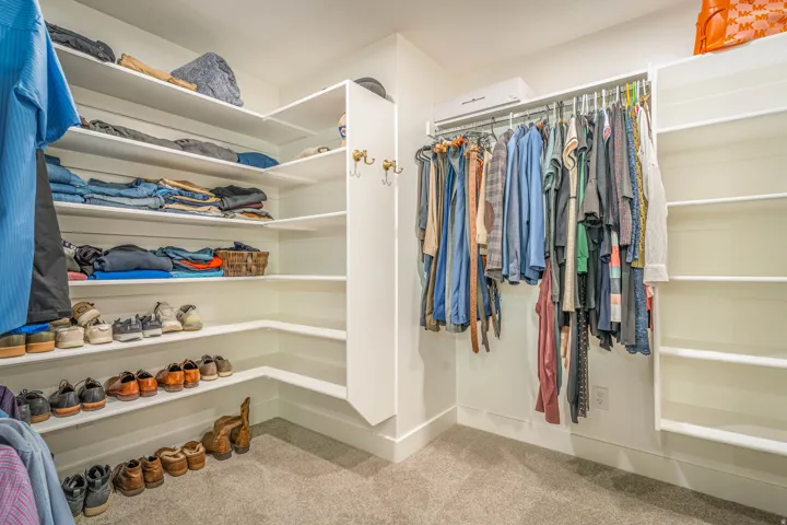 Custom closet system featuring extensive shelving, hanging rods, and built-in storage