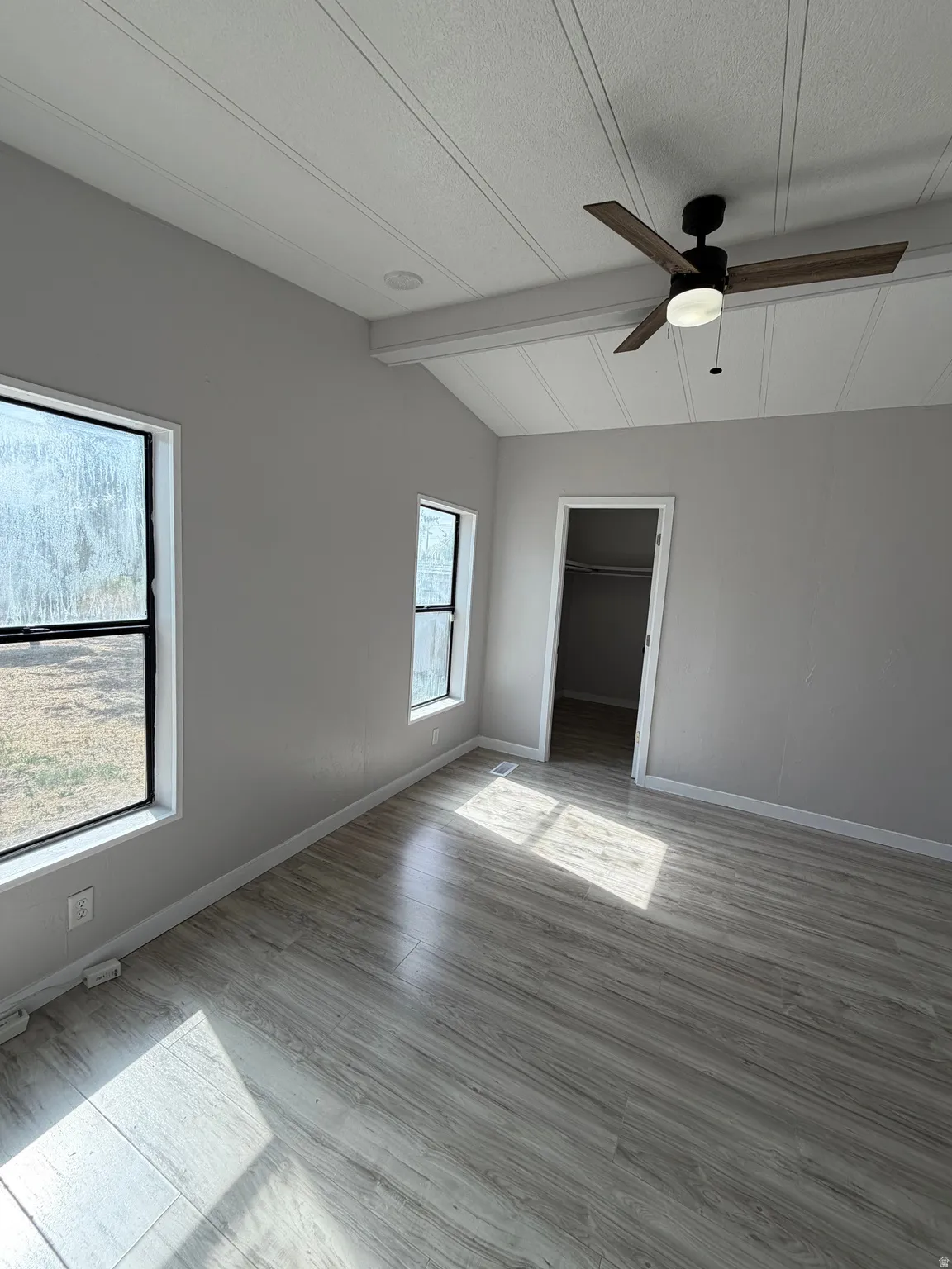 Vaulted ceilings with plank detailing, wood-finish flooring, a modern ceiling fan with light, recessed lighting, and a closet with a bifold door
