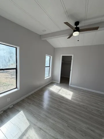 Vaulted ceilings with plank detailing, wood-finish flooring, a modern ceiling fan with light, recessed lighting, and a closet with a bifold door