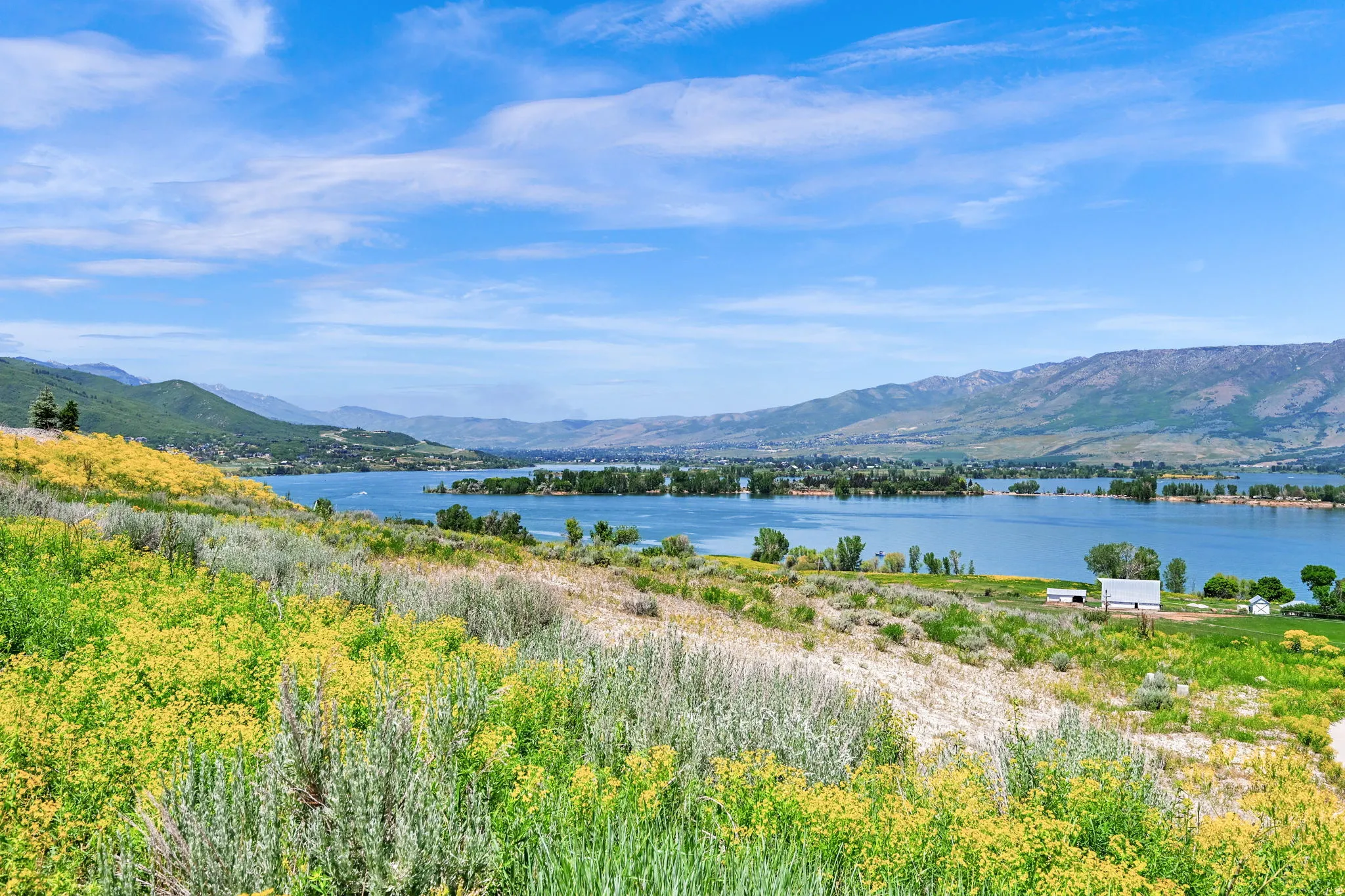Expansive water frontage with mountain backdrop
