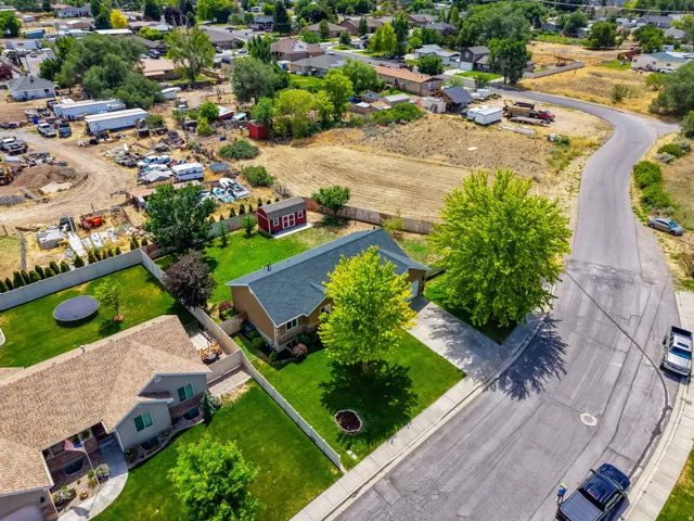 Ranch-style residence featuring attached garage, and a lush green lawn