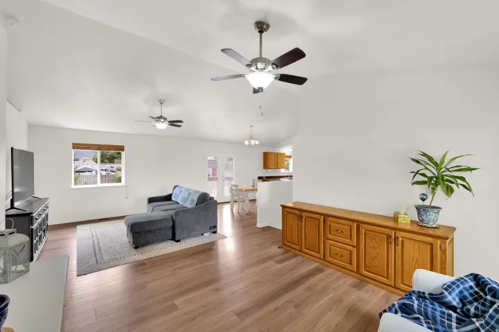 Spacious living area featuring vaulted ceilings and beautiful new flooring.