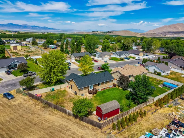 Ranch-style residence featuring a dormered roofline and a fenced backyard