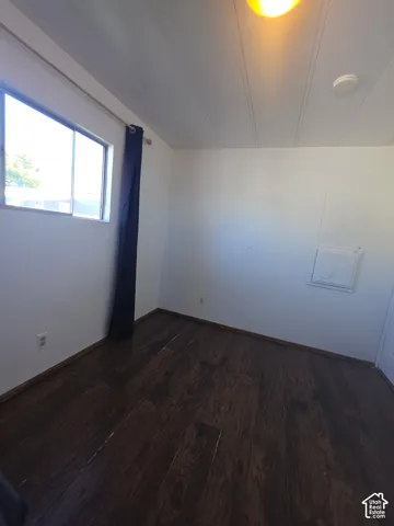 Wood-finish flooring with white walls and a white paneled ceiling