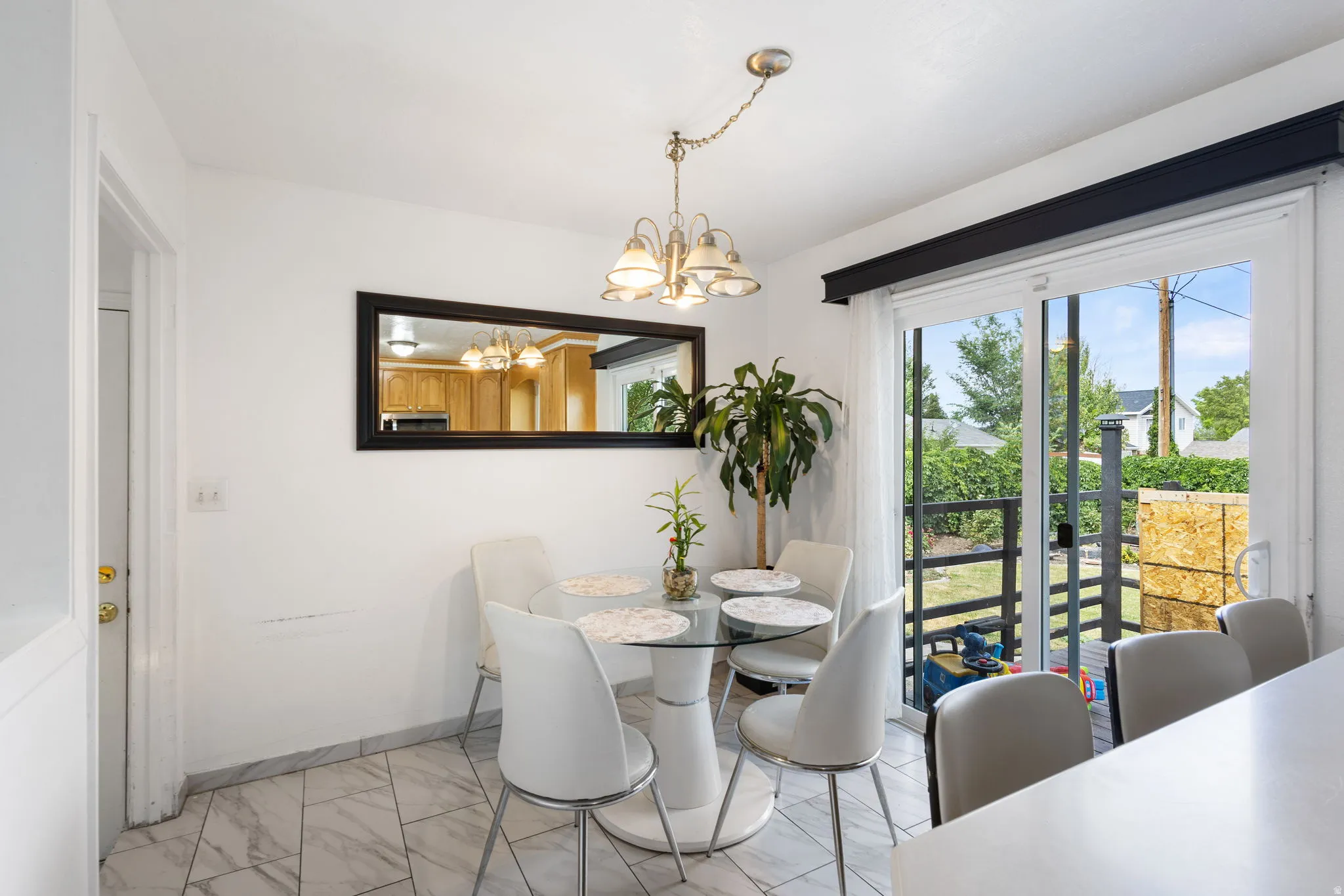 Dining area with white walls and patterned tile flooring