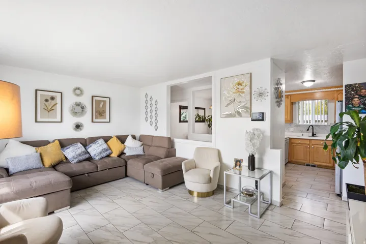 Bright living area featuring light-toned tile flooring