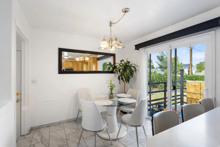 Dining area with white walls and patterned tile flooring
