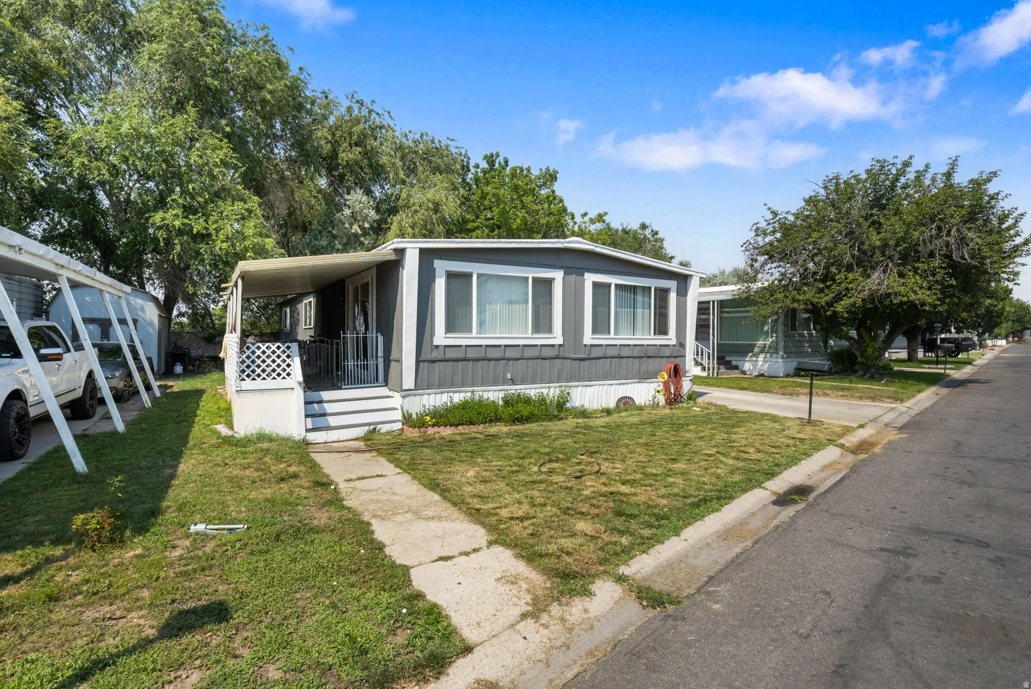 Manufactured home with gray siding and white trim