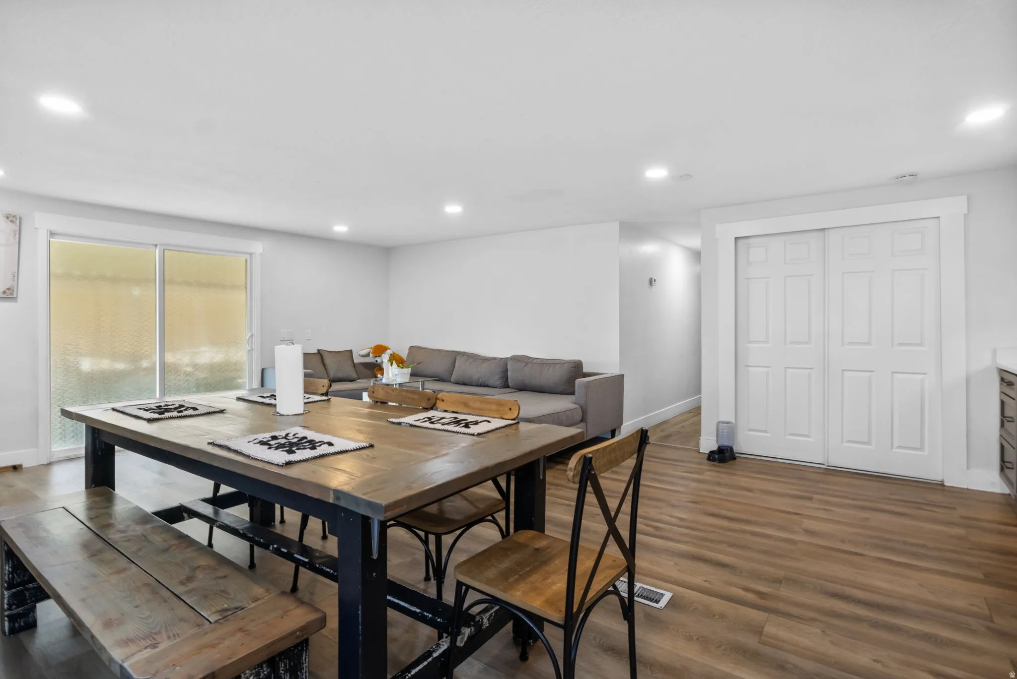 Open-concept interior featuring wood-finish flooring, recessed lighting, and white trim throughout