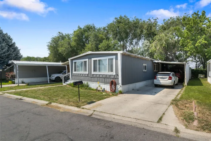 Property exterior featuring gray horizontal siding and white trim