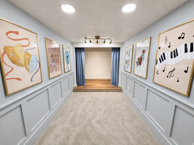 Theater/Stage, featuring a raised wood flooring stage and privacy curtains