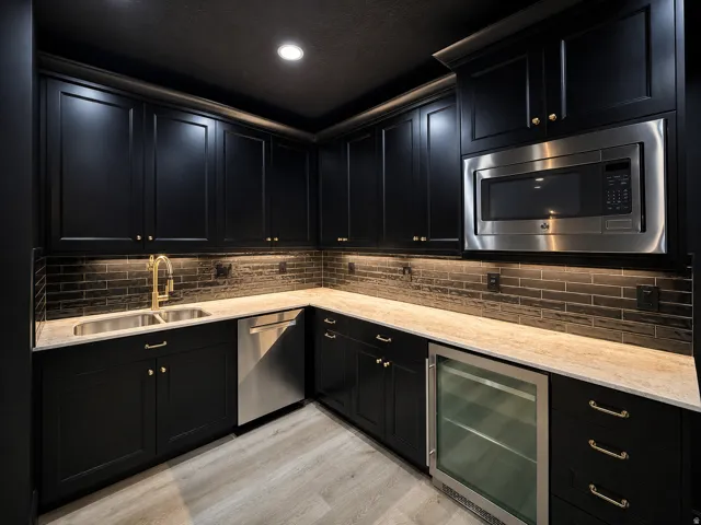 Half kitchen in the theater room with dishwasher, beverage refer, microwave, black shaker style cabs with black subway tile backsplash