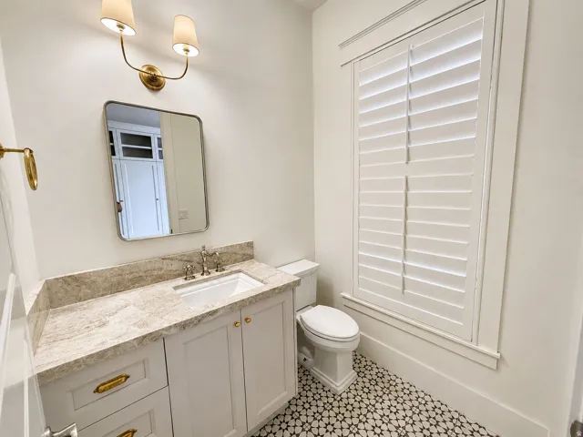 Entry level powder bath with kitchen matching Taj Mahal quartzite counters