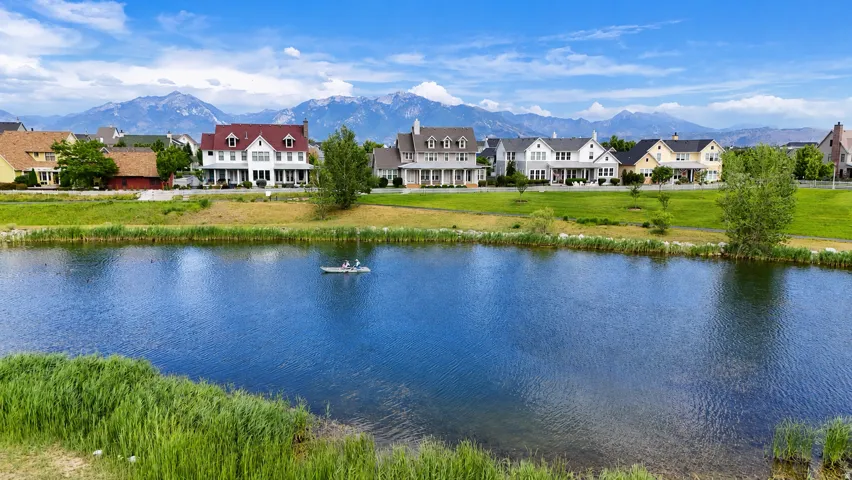 Expansive views of the Oquirrh Lake surrounded by well manicured grass banks
