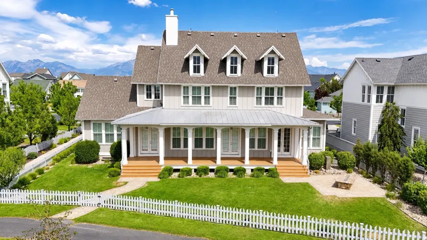 Two-story residence featuring a covered front porch with coordinating metal roof accent
