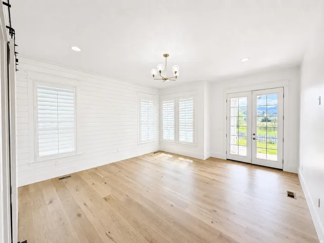 Primary bedroom with covered porch access offering lake and mountain views