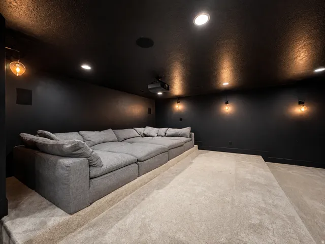 Theater room with Restoration Hardware Cloud Couches, tiered seating  options and theater lighting